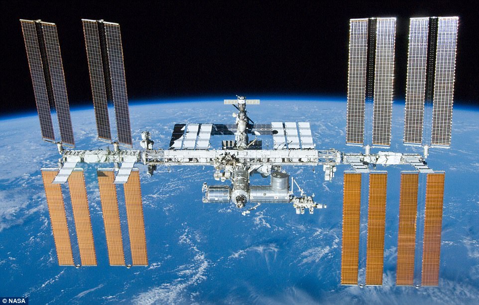 The International Space Station (file photo) is a $100 billion (£80 billion) science and engineering laboratory that orbits 250 miles (400 km) above Earth