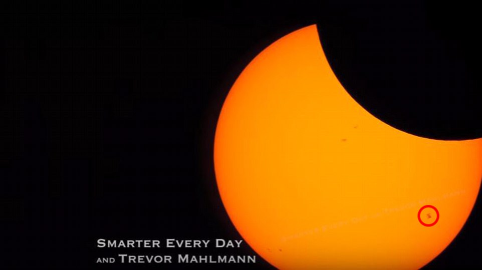 An amateur astronomer has now released a video of the ISS's transit of the sun during the eclipse, showing the huge space station - which is the size of an American football field - gliding across the bright orange solar surface